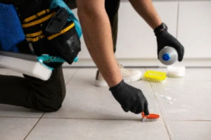 Man performing tile cleaning Bakersfield service restoring dirty floor tiles and grout professionally